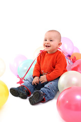 Fototapeta na wymiar Smiling baby with balloons