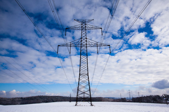 Fototapeta Transmission towers on the field in winter