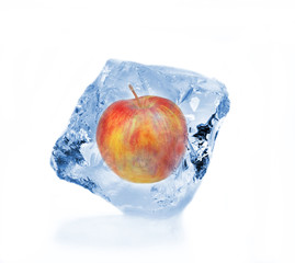 Red apple frozen in ice cube