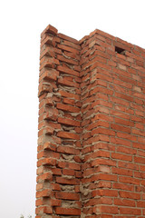 unfinished red brick wall