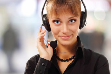 Support phone operator beautful young woman in headset at workpl