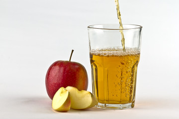 Apple cider pouring down into glass