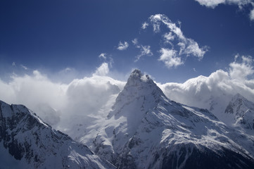 Fototapeta na wymiar High mountains in cloud