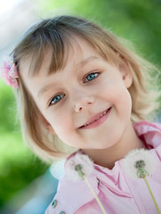 beautiful little girl in a pink raincoat