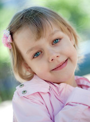 beautiful little girl in a pink raincoat