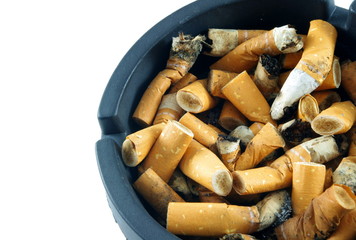 Cigarette butts in ashtray over white surface