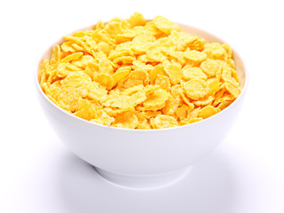Image of bowl full of cornflakes over white background.