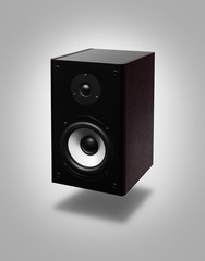 Speaker hanging in the air over gray background