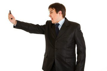 Amazed modern businessman yelling on mobile phone