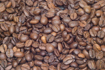 Many roasted coffee beans as background closeup