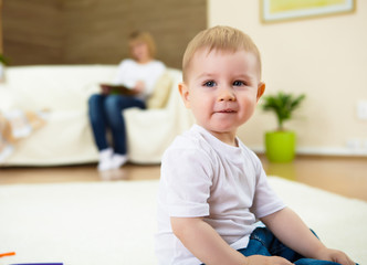 little boy playing on the floor at home