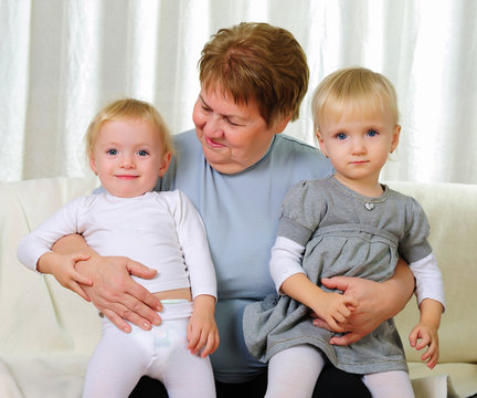 two twins sisters with their grandmother