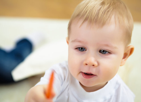 Little Boy Drawing With Color Pencils