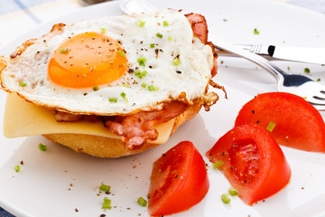 Breakfast - fried egg with bacon and cheese