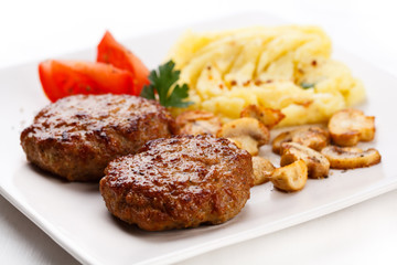 Fried steaks with potatoes and mushrooms