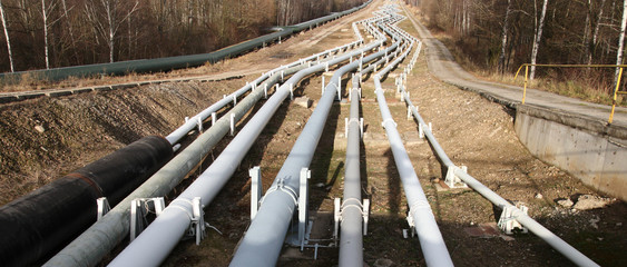 Pipelines leading into the horizon with power-station