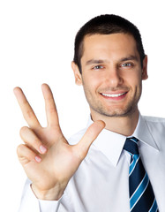 Portrait of smiling businessman showing three fingers, isolated