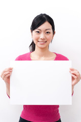 Naklejka premium beautiful asian woman holding blank whiteboard