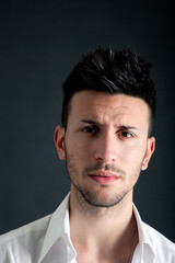 Obraz premium Serious handsome man on dark background