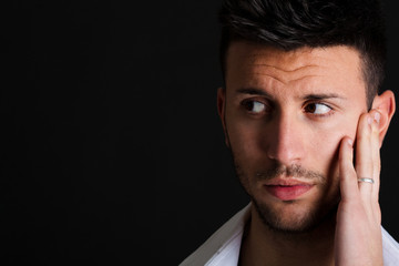 Thoughtful man on dark background