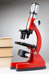books and microscope, scientific or educational concept