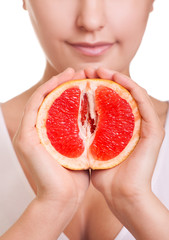 woman with grapefruit in hands close-up