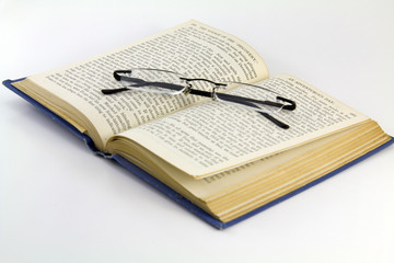 Readin specs sitting on an old book