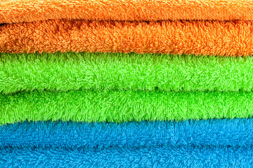 Fototapeta na wymiar background of the three multi colored terry towels
