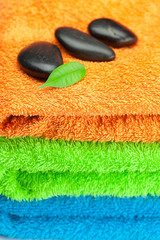Fototapeta na wymiar background of the three multi-colored terry towels and spa black