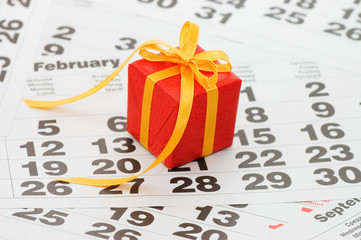 Box with a gift on calendar sheet - - Valentines day