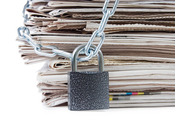 pile of newspapers with chains, on white