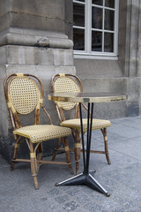 Fototapeta na wymiar Cafe Terrace Table and Chairs in Paris, France
