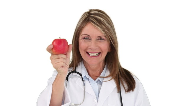 Ederly nurse showing us an apple