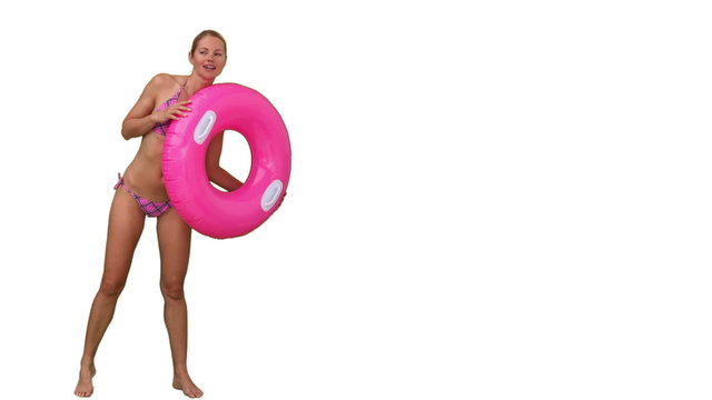 Lady in swimsuit playing with rubber ring