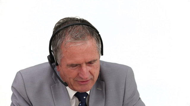 An ederly businessman talking on the phone
