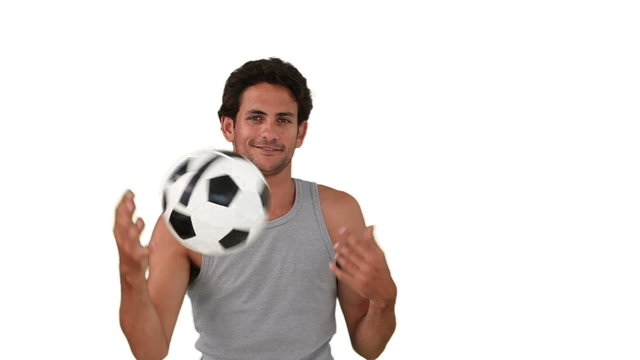 Dark-haired man playing with a soccer ball