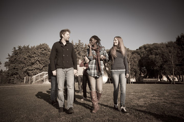 College Students Walking and Talking at Park