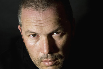 Low key portrait of menacing looking caucasian man