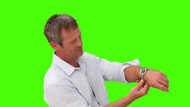 Man in shirt putting on a watch