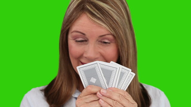 Elderly woman playing with cards