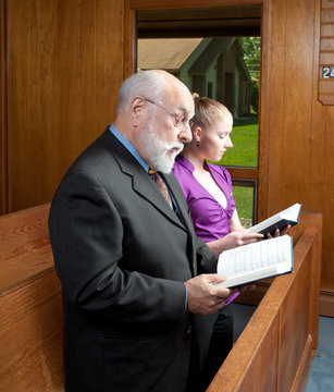 Senior Man Young Woman Church Singing Hymnals