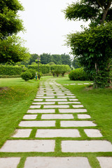 Stone paved path through the park lawn