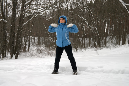 Woman exercising in the fresh air in the winter forest