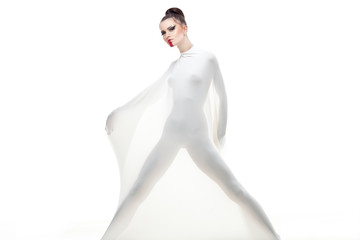 a conceptual studio shot of a young woman dressed in white.