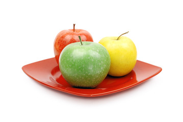 Apples on red plate