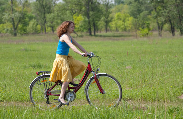 Fototapeta na wymiar girl goes by bicycle