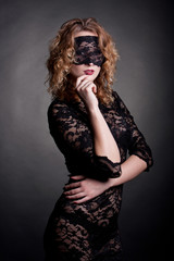 Naklejka premium beautiful woman with red lips and lace mask over her eyes