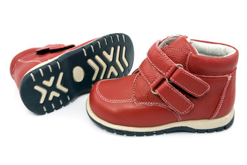 Pair of  child's red  shoes over white background