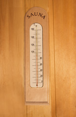 thermometer on wooden wall in sauna.