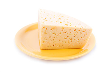 Piece of cheese on yellow plate
